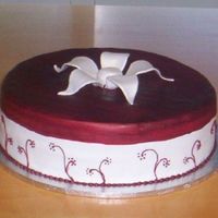 Farewell Cake Chocolate cake with fondant icing. Flowers piped in royal icing, top flower modelling paste and painted with red colouring and lustre dust...