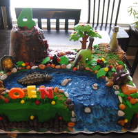 Dinosaur Birthday Cake Dinosaur Birthday Cake with rice crispie volcano and cherry filling lava. Absolutely everything is edible except for the 5 dinos and the...