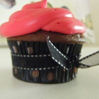 Pink Cupcake Swiss chocolate cupcake with hot pink buttercream icing and a bow to tie it together.