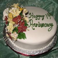 Img_1910.jpg This is a Jamaican Fruit cake covered with fondant and decorated with gum paste flowers.