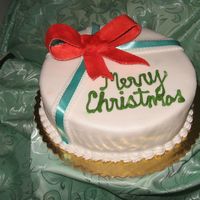 Img_1913_2.jpg This is a Jamaican Fruit Cake covered with fondant and decorated with a gum paste ribbon and satin ribbon.