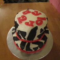 Zebra 8 inch and 6 inch cake. The cake is french vanilla and colored red. All of the decorations are buttercream.