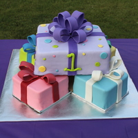 First Birthday Presents Four 6" small presents, one 10" large present, covered in fondant with fondant/gum paste decorations