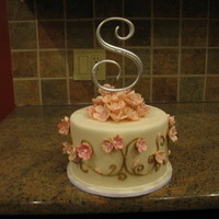 Cherry Blossom Glory sinful chocolate fudge cake with cappaccino filling covered in buttercream and fondant. Flowers are handmade and painted gumpaste