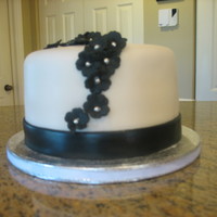 Black And White Affair sinful chocolate with chocolate buttercream filling covered in ivory fondant and fondant flowers