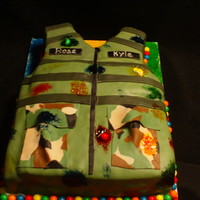Paintball Vest Cake The cake is half chocolate and half vanilla, with butter cream icing. I covered the cake in fondant. The paint spots are food coloring with...