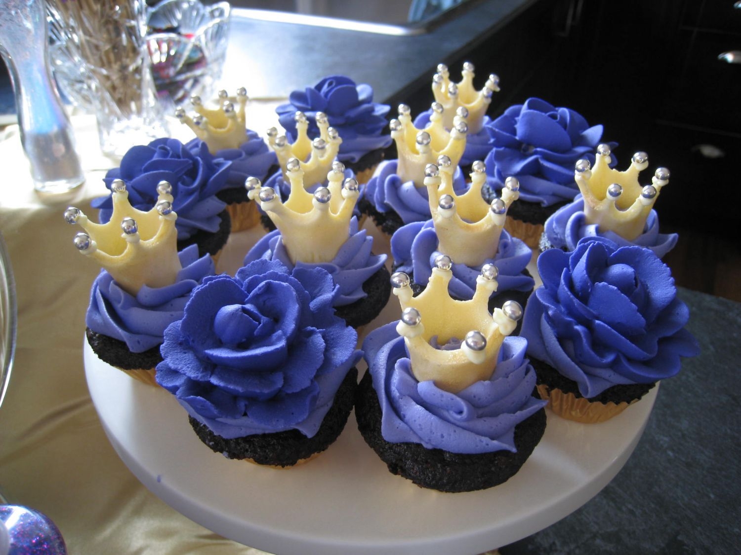 Crowns-N-Roses Cupcakes for the princess party.No sugar added chocolate cupcakes, buttercream icing. MMF crowns painted with gold pearl dust. Royal icing...