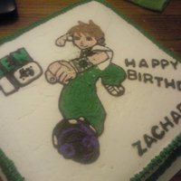 Ben 10 Yellow cake w/ sprinkles, buttercream icing, green sugar pearls, green nonperials.