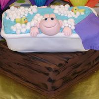Baby In A Bath Tub Baby shower cake - rolled fondant, water is decorator icing. Top cake is chocolate pound, bottom is vanilla pound