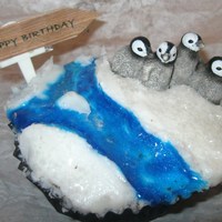 Penguin Birthday Cupcake I made this for my mom's birthday. Our thing together is penguins :) i used regular white icing for ice, blue sprinkle gel for water,...