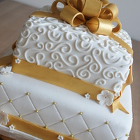 White And Gold Wedding Cake! Wedding cake in white and gold, with a bow on top!