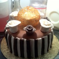 Modeling Chocolate With Roses, Caramel Cage. This is a cake covered in modelling chocolate. The white roses are fondant and borwn roses modelling chocolate. It has a caramel cage with...