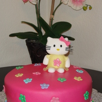 Hello Kitty With Colorful Blossoms Hello Kitty with a dress, colorful blossoms and pearl border. Made marshmellow fondant for the first time, it was very messy and harder to...