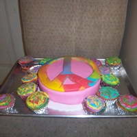 Peace Of Cake Cake covered in fondantPeace sign made from tie dye fondant (inside was also tie dye)Cupcakes covered in buttercream in a tie dye design