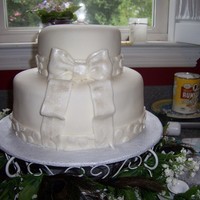 Small Fondant Wedding Cake With Bow I made this cake for a friend's wedding, using the lemon-flavored version of the white almond sour cream wedding cake recipe. It'...