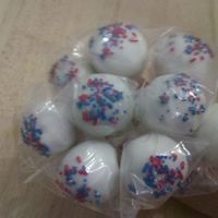 4Th Of July Round Pops Red velvet cake pops. Dipped in vanilla melts and red, white, and blue sprinkles on top.