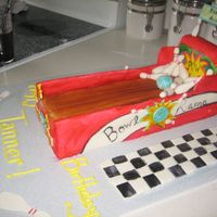 Side View Of Bowling Lane Bowling Lane cake covered in fondant with some additional hand painted detail