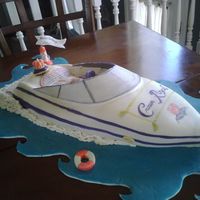 It's Crown Time Boat Crown Royal themed sports boat carved then covered in fondant. Hand Painted embellishments with food coloring.
