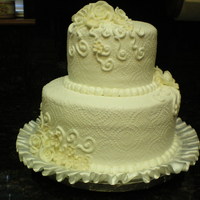 Small But Sweet Simple floral design and swirls to accent this round wedding cake.