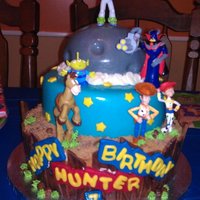 Hunter's Toy Story Cake This is a cake I made for a friend of mine's step son who absolutely loves toy story. Although the figures aren't edible, I think...