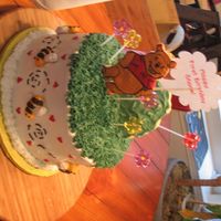 Winnie The Pooh 1St Birthday Cake I made this cake for my friend, it was her son's 1st birthday and the theme was Pooh. The top is decraoted with coolies and the bees...