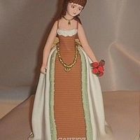 Victorian Inspired Lady. Made on a styrofoam-cone. Skirts made of sugarpaste, hair is royal icing.