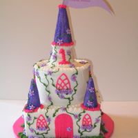 Pink And Purple Castle Castle spires made with cones covered in icing and sprinkles.