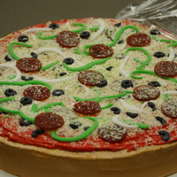 Yummy Pizza Cake I baked a white 12 inch cake. iced in buttercream. Fondant pieces made the olives, peppers, onions. Pepperoni are made of organic fruit...
