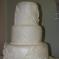 White Wedding Cake Three tier cake all white with hand piped lace.