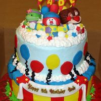Jojo's Circus Jojo and friends are fondant/gumpaste mix. Cake is iced in BC with fondant accents.