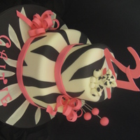 Caitie Zebra Cake 10 and 6 inch strawberry cake with buttercream and fondant. Bows, cat, lettering and numbers are gumpaste. Thanks for looking!