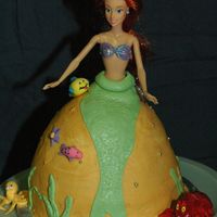 Ariel Cake Lemon cake with bc frosting, fondant accents and Ariel doll in the middle. This was for my daughter's 5th birthday. She made all of...