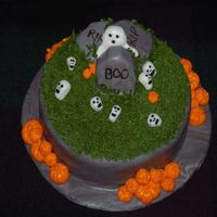 Skulls And Pumpkins 2 layered cake with buttercream icing and handmade MMF decorations.