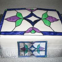 Stained Glass Cake 9x13 chocolate cake covered in fondant with coloured piping gel for the stained glass effect. This was made for a friend at work. The...