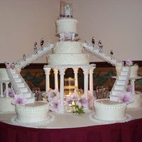 Large Cake/fountain This was the cake they picked but 2 are fake. They only had 200 at the wedding. Yellow cake and buttercream, silk flowers