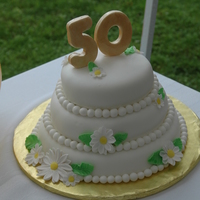50Th Anniversary Cake Anniversary cake for husband's grandparents. Fondant covered cake with gumpaste flowers and 50. (It was so humid that day the 50 began...