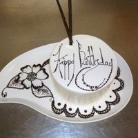 Chocolate Henna small bday cake on paisley plate. Henna design drawn in writing chocolate