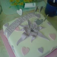 Nana's 75Th Birthday Cake parcel cake - Sponge covered in sugarpaste with hearts and stars on wires (use flower pick with small blob of sugarpaste to hold wires)