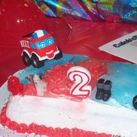 Fire Truck 2Nd Bday Cake buttercream funfetti cake.Piped on border and sprayed on color.Used simple toys and candles to decorate.