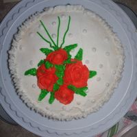 Wilton Roses final!Orange roses and a neon green leaves.Also a blue bow on the edge.I was pleased with it!I wish i had more time to do it.