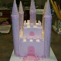Princess Castle Cake Cake is covered in buttercream. Towers are cardboard tubes frosted with royal icing and sanding sugar. Fondant was used for accents. The...