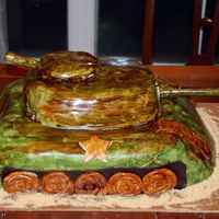 Army Tank Groom's Cake 12x18 Chocolate Chip cake carved with Satin Ice Fondant. Hand painted camo. Guns are made out of gumpaste. Thanks for looking!