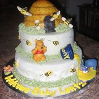 Pooh Baby Shower Pooh Baby shower cake is covered in MMF with royal icing "grass" to help support the layers. The beehive is made of Rice Krispie...