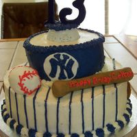 Ny Yankees Birthday Birthday cake with bc frosting and fondant accents. Baseball and bat are rice krispies treats covered in fondant.