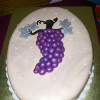 Cluster Of Grapes I held a wine and cheese party and this is the cake I made for it. Covered in MMF and the grapes and leaves are made from gumpaste