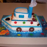 Tugboat Cake This is iced in buttercream with candy accents. The smoke stack is a plastic dowel covered in fondant and the "smoke" is cotton....