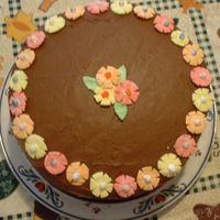 Squished Marshmallow Flowers This is a checkerboard cake with chocolate frosting. The flowers are colored, mini marshmallows rolled flat, petals cut with small scissors...