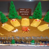 Camping Cake I got the directions for this cake off of Wilton.com. It's almost exactly like what they have with one exception. I melted chocolate...