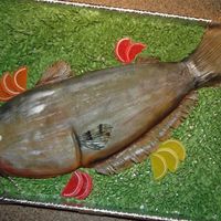 Catfish Cake Catfish sculpted cake. Buttercream covered w/ fondant. Color is airbrushed on and shimmer is brushed over for a wet look. Docorations are...