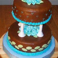 Brown Wedding Cake French vanilla cake with raspberry yogurt filling, fondant and BC icing, fondant roses and leaves.